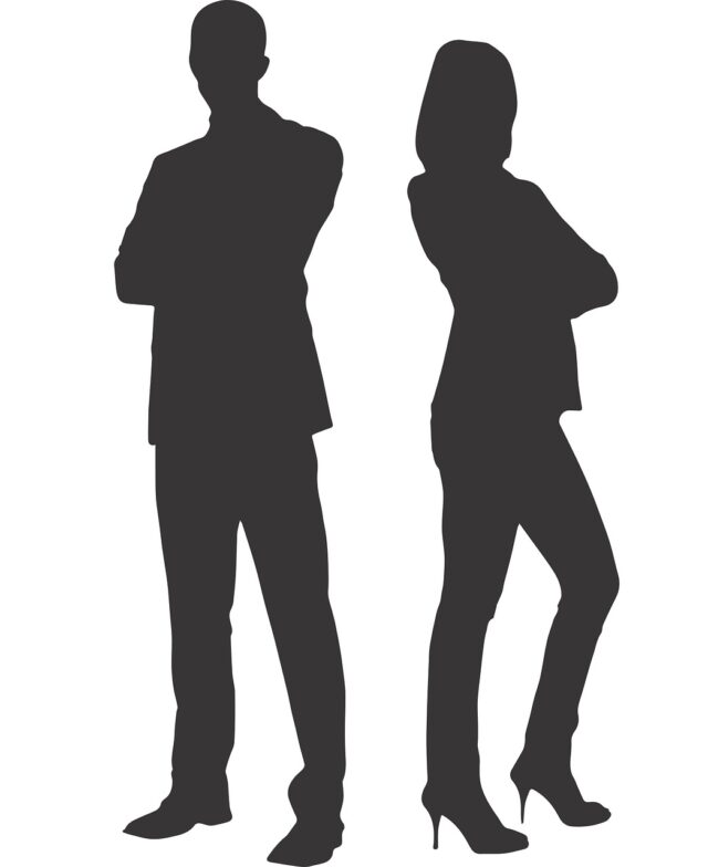 Silhouettes of a man and a woman standing back-to-back, both dressed in business attire, engaging in divorce mediation. The man wears a suit, and the woman wears a dress and heels.