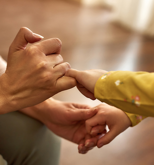 Hands of child and elderly woman making pinkie promise