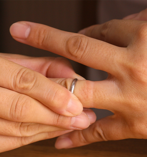 person taking off a wedding ring