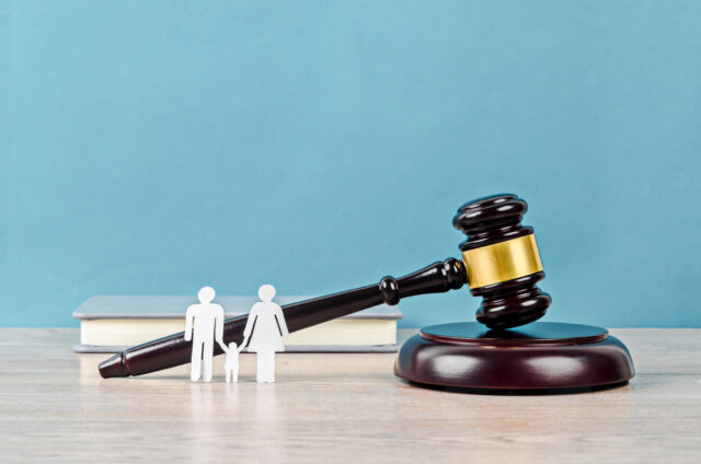 Family figure and gavel on table. Family law concept